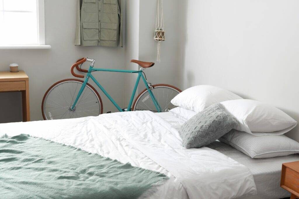 A bicycle next to a bed