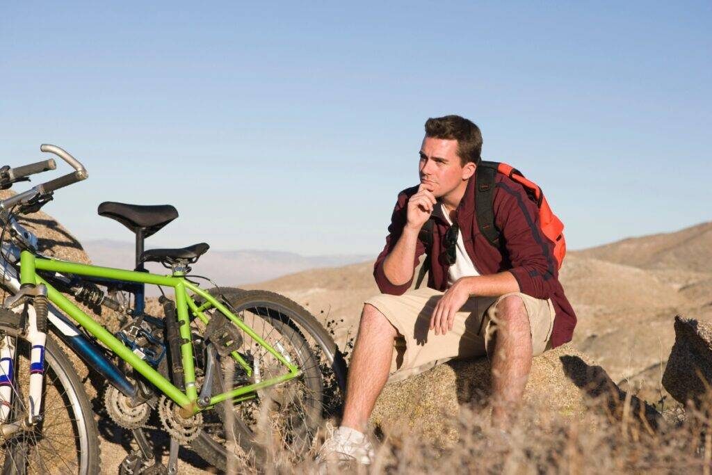 Male cyclist in thought